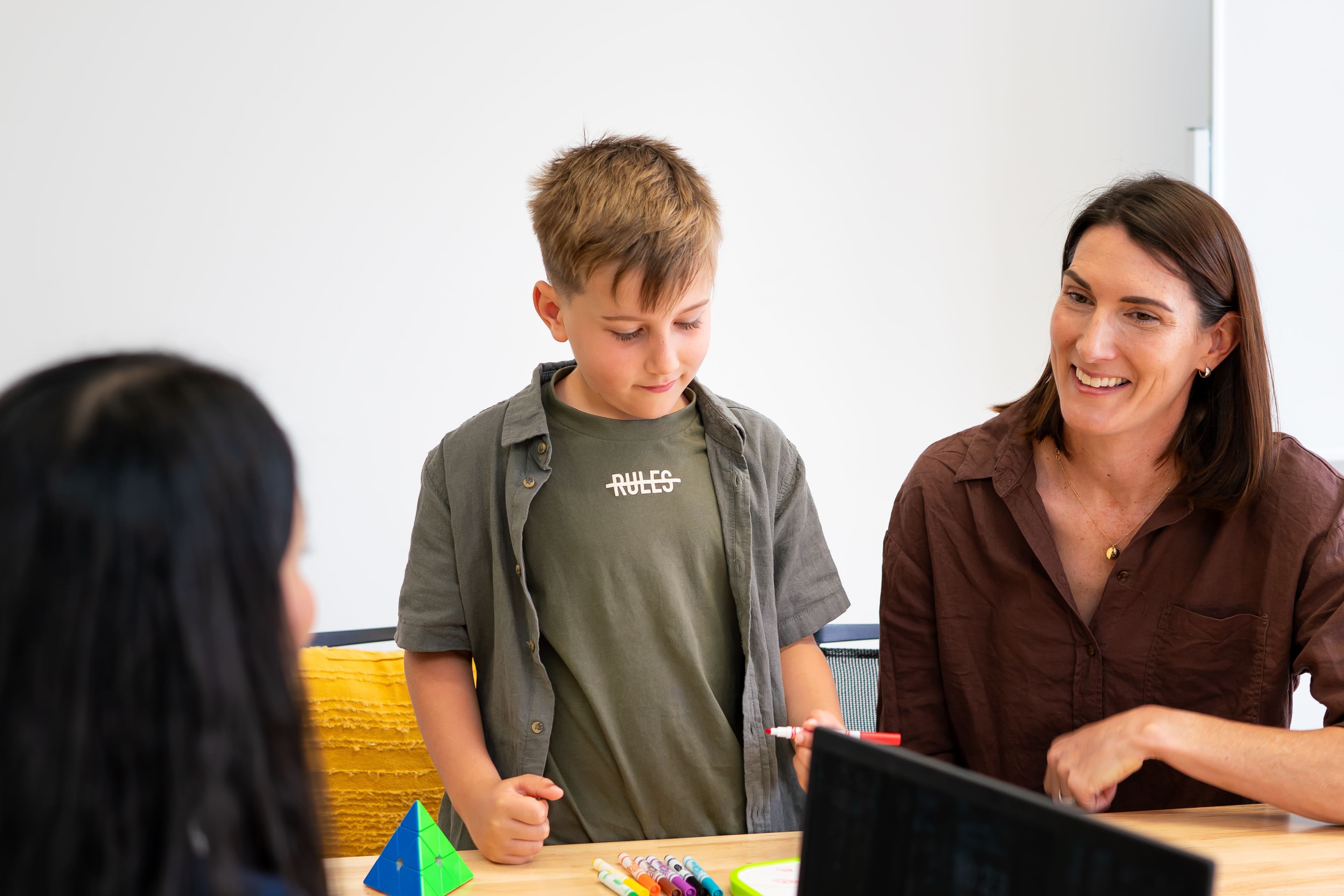 A child, mum and a clinician at a table