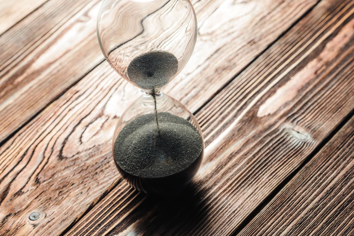 An hourglass on a wooden table